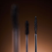 DEAR DAHLIA Paradise Dream Lash Defining Mascara by ProtoClinical shown in k-beauty mascara packaging with a warm beige center on a deep brown background.