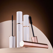DEAR DAHLIA Paradise Dream Lash Volumizing Mascara by ProtoClinical shown in k-beauty mascara packaging with a warm beige center on a deep brown background.