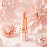 ProtoClinical k-beauty DEAR DAHLIA Paradise Tinted Blooming Balm close-up of soft beige product packaging with muted taupe panels on a light background