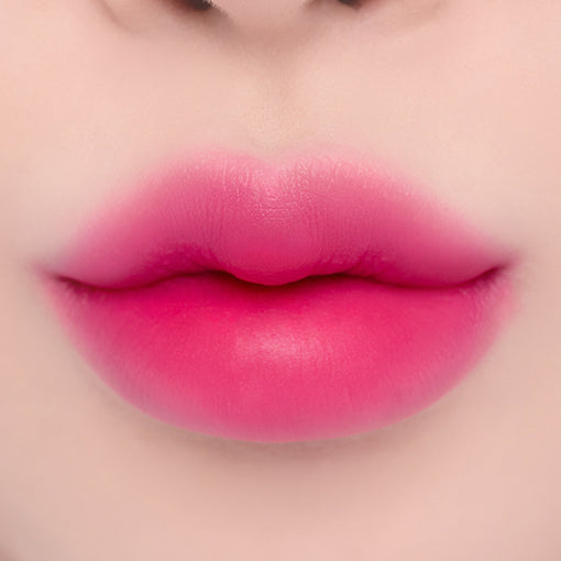 ProtoClinical k-beauty espoir Nowear Lipstick Volume Matte 3g (8 colors) close-up of centered lips with a soft blurred gradient and vivid fuchsia-pink lip color