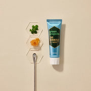 ProtoClinical k-beauty MEDIAN Green-Propolis Toothpaste Pure Mint 100g*3 as a single dark green toothpaste tube on a cream background beside white hexagon dishes with mint leaves and honeycomb