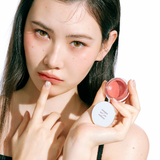 ProtoClinical k-beauty HERA Sensual Lip & Cheek 7g model portrait featuring soft nude-pink lip and cheek makeup on a light background.