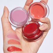 ProtoClinical k-beauty HERA Sensual Lip & Cheek 7g model portrait featuring warm coral lip and cheek makeup on a light background.