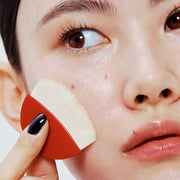 ProtoClinical k-beauty HERA Skin Tint Comfy Spreader SPF50/ PA++++ 15g portrait-style beauty visual on a warm neutral background.
