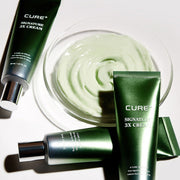 ProtoClinical k-beauty [KIM JEONG MOON Aloe] Cure+ Signature 3X Cream 50ml as a single dark green cream package centered upright with pale green side accents on a soft mauve background