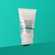 ProtoClinical k-beauty ILLIYOON Cica Acne Clear Peeling Scrub 200g single upright mint scrub tube centered on a teal background.