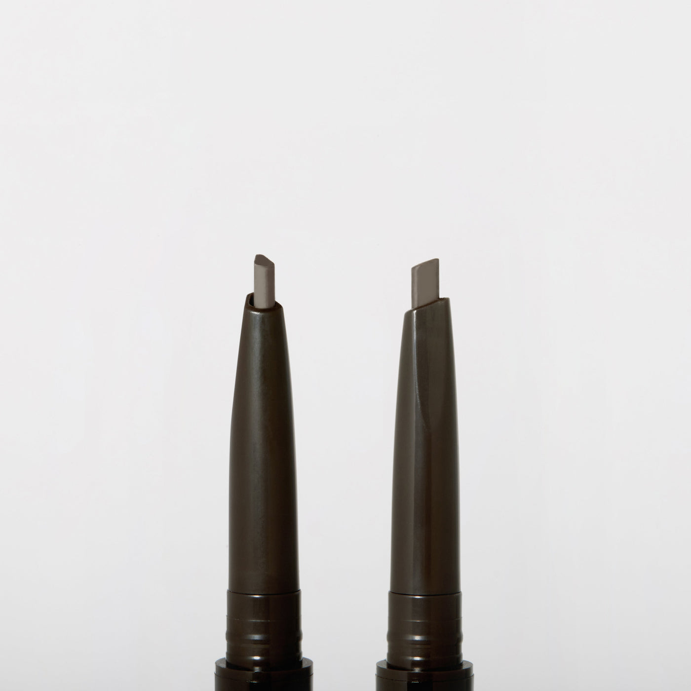 ProtoClinical k-beauty JUNGSAEMMOOL Artist Brow Shader 0.18g two slim gray brow product silhouettes on a white background.