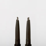 ProtoClinical k-beauty JUNGSAEMMOOL Artist Brow Shader 0.18g two slim gray brow product silhouettes on a white background.