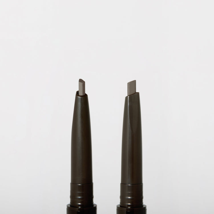 ProtoClinical k-beauty JUNGSAEMMOOL Artist Brow Shader 0.18g two slim gray brow product silhouettes on a white background.