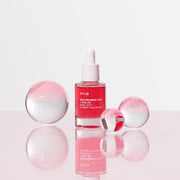Anua Niacinamide 10% + TXA 4% Serum 30ml pink bottle on aqua and pink background