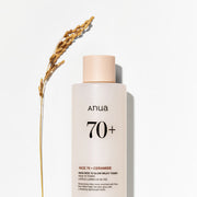 ProtoClinical k-beauty Anua Rice 70 Glow Milky Toner 250ml single upright pale beige toner bottle centered on a pale blue and peach background
