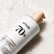 ProtoClinical k-beauty Anua Rice 70 Intense Moisturizing Milk 150ml angled gray bottle on a pale lilac and cream background