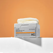 ProtoClinical k-beauty warm orange beauty product with a cool gray center shape on a light background.