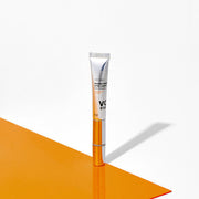 ProtoClinical k-beauty gray beauty product with pale blue accents above warm orange tones on a light background.