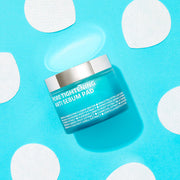 ProtoClinical k-beauty bright aqua beauty product silhouette with soft gray-blue side panels on a light background.