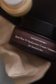 ProtoClinical k-beauty tall charcoal beauty product silhouette on an olive brown background.
