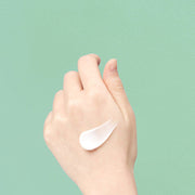 ProtoClinical k-beauty pale aqua beauty bottle silhouette with a cream center and warm beige lower accent on a light background.