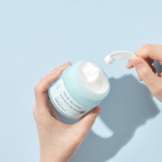 ProtoClinical k-beauty pale blue beauty bottle silhouette with a soft white center and charcoal lower section on a light background.