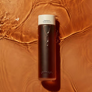 ProtoClinical k-beauty warm brown beauty graphic with a soft golden vertical center on a muted background.