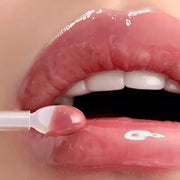 ProtoClinical k-beauty primera Retinol Volume Lip Serum 12g in a close-up of glossy pink lips with a doe-foot applicator applying clear pink serum