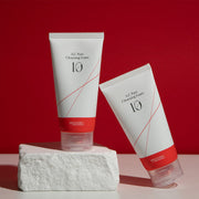 ProtoClinical k-beauty red beauty product detail with pale blue side accents on a light background.