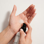 ProtoClinical k-beauty pale blue beauty product detail with a dark horizontal center on a muted gray background.