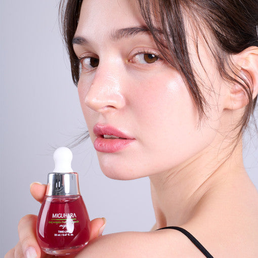 ProtoClinical k-beauty pale pink beauty product detail with dark plum side accents on a light background.