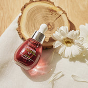 ProtoClinical k-beauty warm gold beauty product detail with a dark brown center on a pale background.