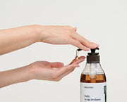 ProtoClinical k-beauty muted green beauty product detail with a dark lower edge on a light background.