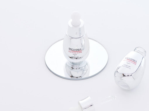 ProtoClinical k-beauty soft olive beauty product silhouette with a dark center on a light background.