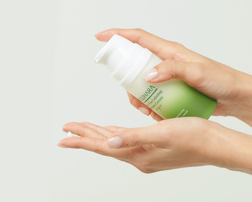 ProtoClinical k-beauty warm beige beauty product detail with soft golden tones on a light background.