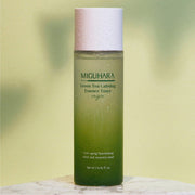 ProtoClinical k-beauty olive beauty product silhouette with a soft yellow center on a light background.