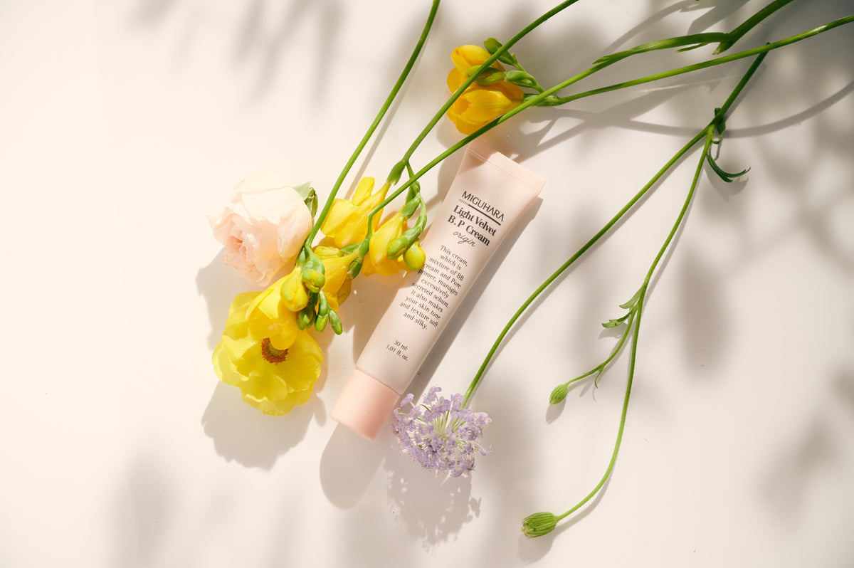 ProtoClinical k-beauty warm beige beauty product detail with soft gray and pale blue edges on a light background.