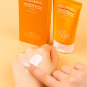 ProtoClinical k-beauty warm orange beauty product detail with soft peach and pale green tones on a light background.