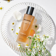 ProtoClinical k-beauty peach-toned beauty product detail on a pale blue background.