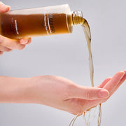 ProtoClinical k-beauty warm beige beauty product detail with soft horizontal bands on a light background.
