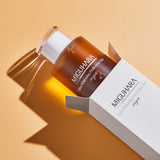 ProtoClinical k-beauty warm beige beauty product detail on a soft peach and pale blue background.