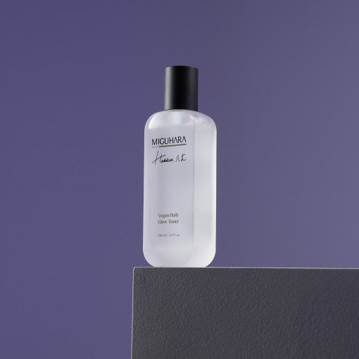 ProtoClinical k-beauty dark lavender beauty product silhouette with a soft pale vertical center on a muted background.
