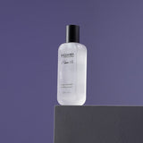 ProtoClinical k-beauty purple beauty product silhouette centered on a dark lavender background.