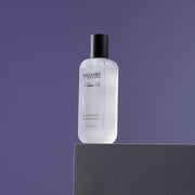 ProtoClinical k-beauty purple beauty product silhouette centered on a dark lavender background.
