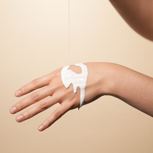 ProtoClinical k-beauty beige beauty product detail with soft gray and cream horizontal bands.