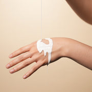 ProtoClinical k-beauty beige beauty product detail with soft gray and cream horizontal bands.