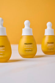 ProtoClinical k-beauty tall warm orange beauty product on a pale blue and white background.
