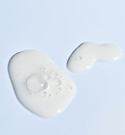 ProtoClinical k-beauty pale blue beauty graphic with a soft light center on a light background.