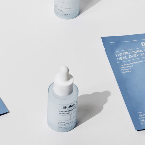 ProtoClinical k-beauty BIODANCE: Hydro Cera-nol Ampoule (30ml) upright pale blue dropper bottle on a white surface with blue product cards and a cropped second bottle