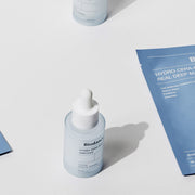 ProtoClinical k-beauty BIODANCE: Hydro Cera-nol Ampoule (30ml) upright pale blue dropper bottle on a white surface with blue product cards and a cropped second bottle
