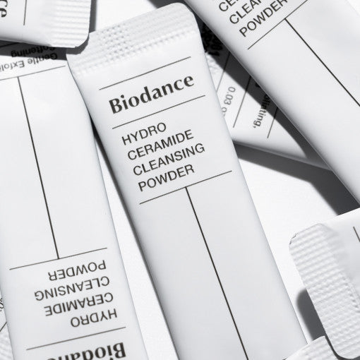 ProtoClinical k-beauty soft gray beauty graphic with layered white and charcoal bands on a light background.