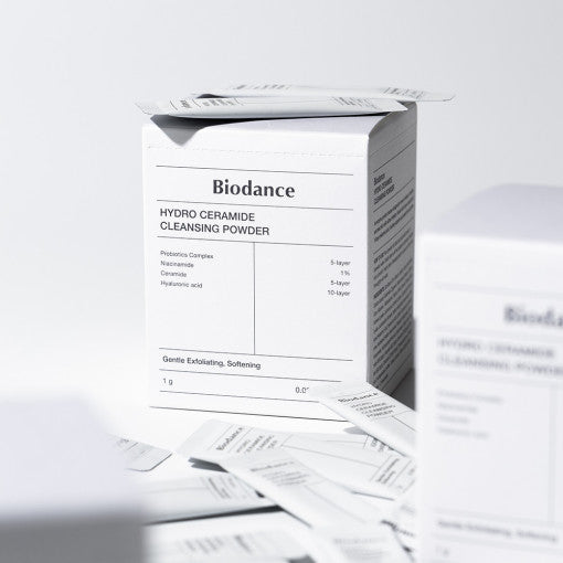 ProtoClinical k-beauty white beauty packaging with soft gray and charcoal vertical forms on a clean background.