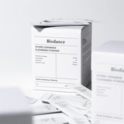 ProtoClinical k-beauty white beauty packaging with soft gray and charcoal vertical forms on a clean background.