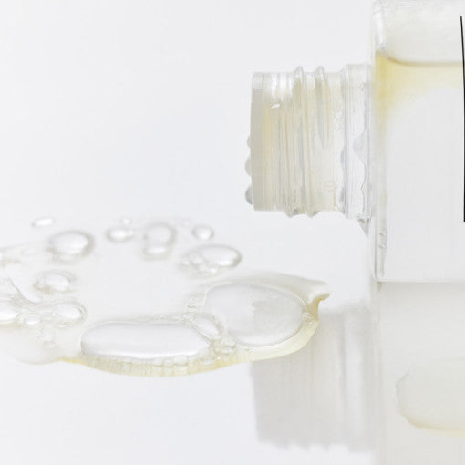 ProtoClinical k-beauty soft beige beauty packaging with a taupe vertical center on a light background.
